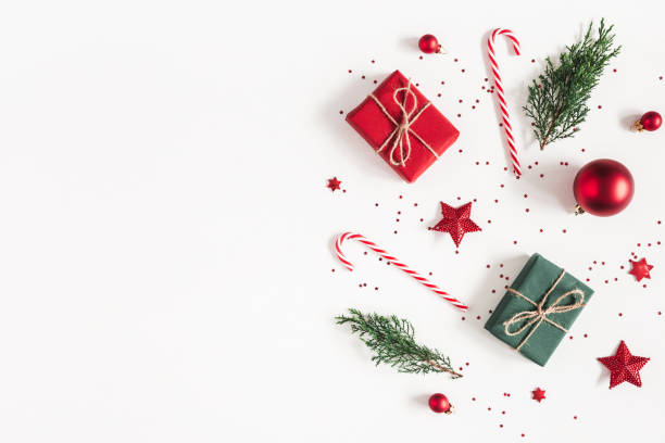 istock Christmas composition. Gifts, fir tree branches, red decorations on white background. Christmas, winter, new year concept. Flat lay, top view, copy space 1054004426