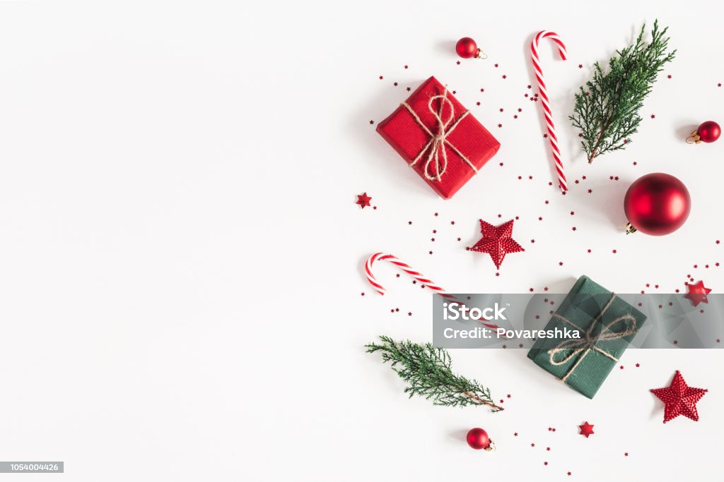 Christmas composition. Gifts, fir tree branches, red decorations on white background. Christmas, winter, new year concept. Flat lay, top view, copy space Christmas Stock Photo