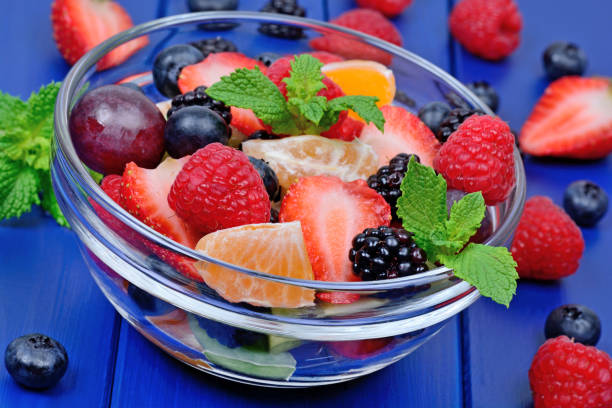 istock Colorful fruit salad in a transparent bowl 1054004582