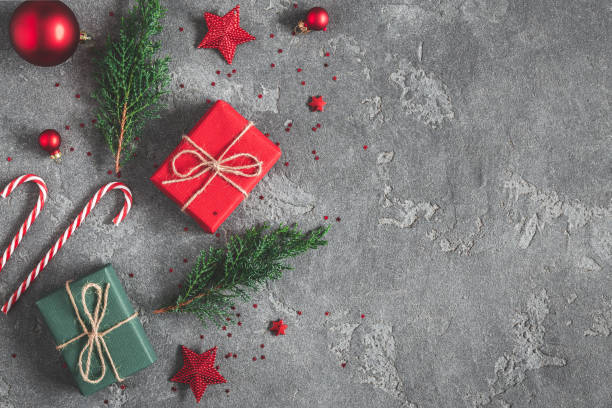 istock Christmas composition. Gifts, fir tree branches, red decorations on black background. Christmas, winter, new year concept. Flat lay, top view, copy space 1054004656