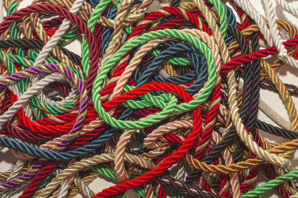 istock Decorative multicolored cords of ropes scattered in a chaotic manner. Textile industry, thread, decoration 1054007020