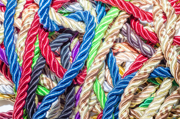 istock Decorative multicolored cords of ropes scattered in a chaotic manner. Textile industry, thread, decoration 1054007286