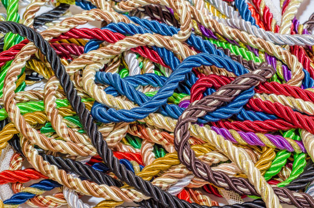 istock Decorative multicolored cords of ropes scattered in a chaotic manner. Textile industry, thread, decoration 1054007808