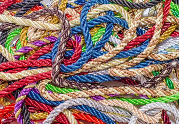 istock Decorative multicolored cords of ropes scattered in a chaotic manner. Textile industry, thread, decoration 1054007918