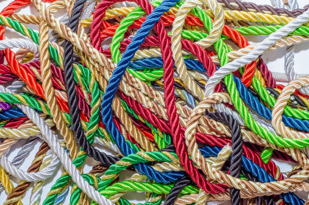istock Multi-colored braided decorative laces scattered in a mess. Textile manufacture, threads, decor. 1054008382