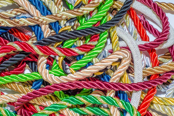 istock Multicolored thick ropes, chaos. Textile manufactory, home decoration, holiday. 1054008394