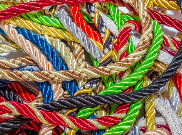 istock Multi-colored braided decorative laces scattered in a mess. Textile manufacture, threads, decor. 1054008402