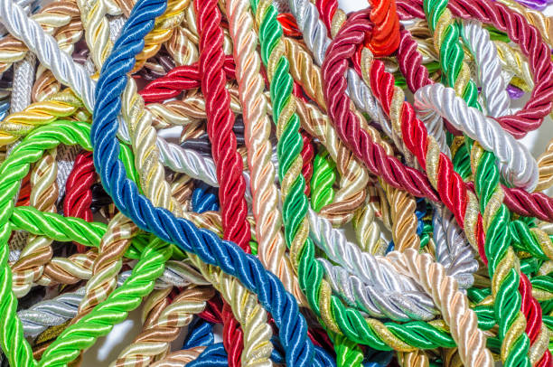istock Multi-colored braided decorative laces scattered in a mess. Textile manufacture, threads, decor. 1054008404