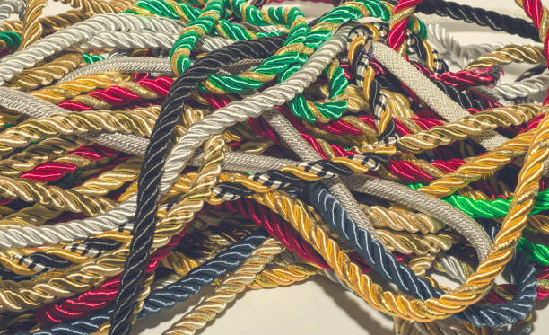 istock Multi-colored decorative rope scattered in a mess. Textile manufacture, threads, decor. 1054008424