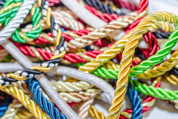 istock Multi-colored braided decorative laces scattered in a mess. Textile manufacture, threads, decor. 1054008494