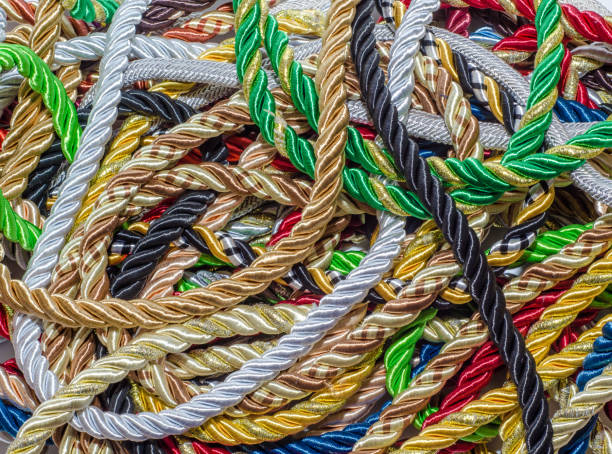 istock Multi-colored decorative rope scattered in a mess. Textile manufacture, threads, decor. 1054008584