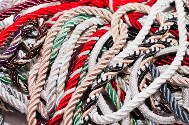 istock Multi-colored braided decorative laces scattered in a mess. Textile manufacture, threads, decor. 1054008598