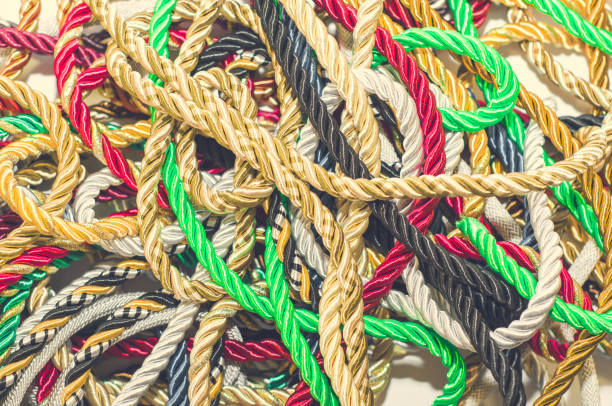 istock Multi-colored braided decorative laces scattered in a mess. Textile manufacture, threads, decor. 1054008600