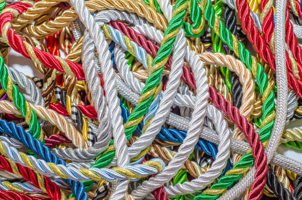 istock Multicolored thick ropes, chaos. Textile manufactory, home decoration, holiday. 1054008650
