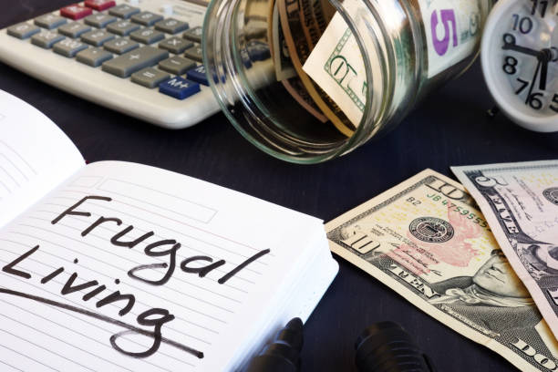 istock Frugal living written on a note pad and money. 1054011700