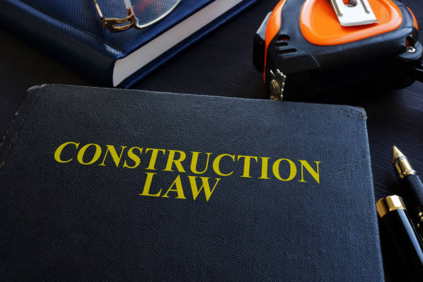 istock Construction law. Book and glasses on a wood. 1054011802