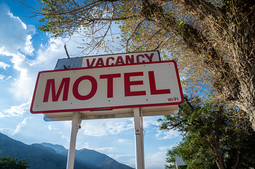 Close up view of a generic abandoned old motel sign, with vacancy on a sunny California day