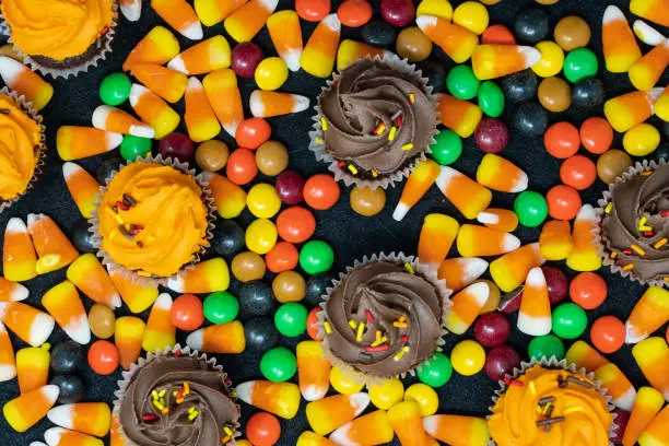 Close up view of Halloween candy corn and, cupcakes and chocolate candy