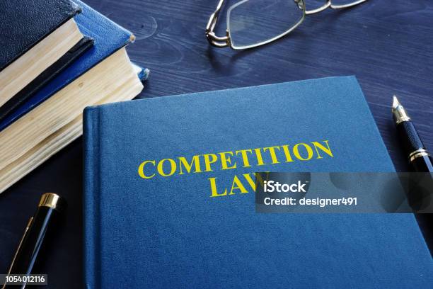 Competition Law And Pen On A Table Stock Photo - Download Image Now - Law, Competition, Economic Cartel