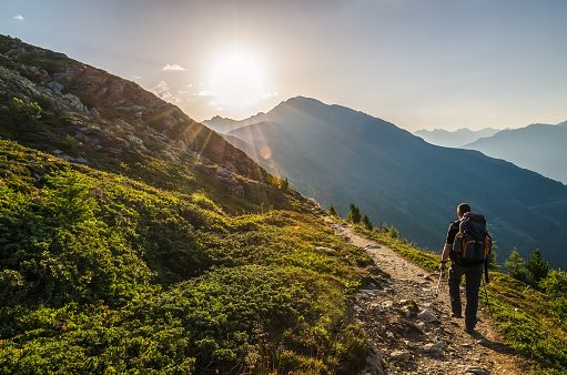 Venetberg, Austria - August 02 2017: Single hiker in the early morning at sunrise on a trekking path in the Lechtaler Alps