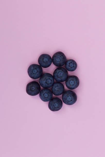 istock Blueberries on the pink background. 1054015150