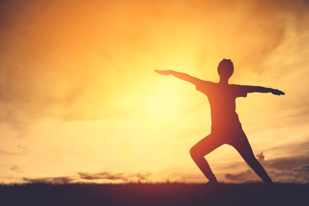 istock Silhouette Woman Exercising On Field Against Orange Sky During Sunset 1054035136