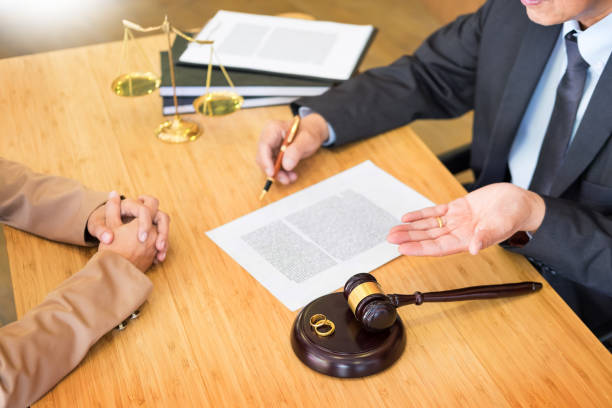 istock Midsection Of Lawyer Sitting With Client At Office 1054040288