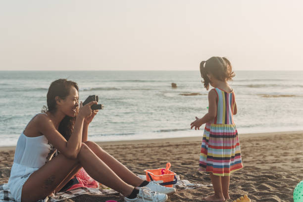 istock Mother photographing little daughter 1054041270