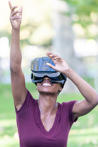 smiling black Woman using virtual reality headset