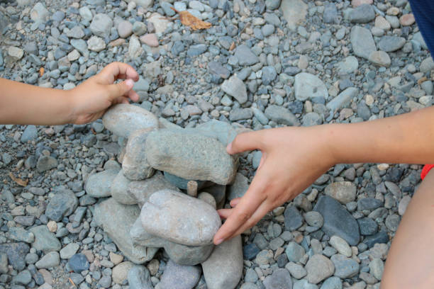 istock Mother and Child Building with Rocks Together 1054047874