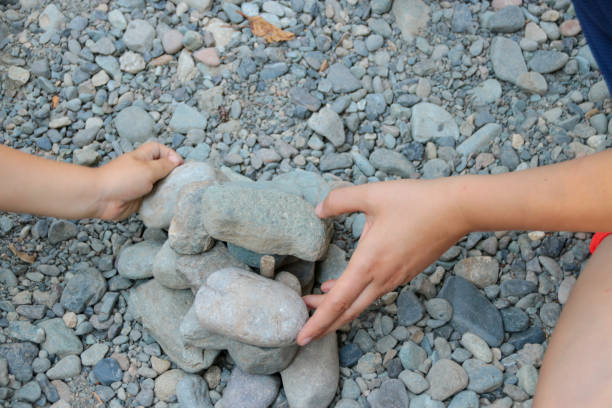 istock Mother and Child Building with Rocks Together 1054047914