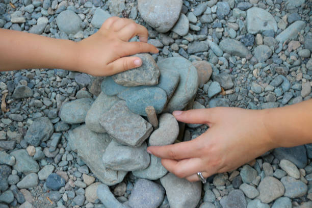 istock Mother and Child Building with Rocks Together 1054048004