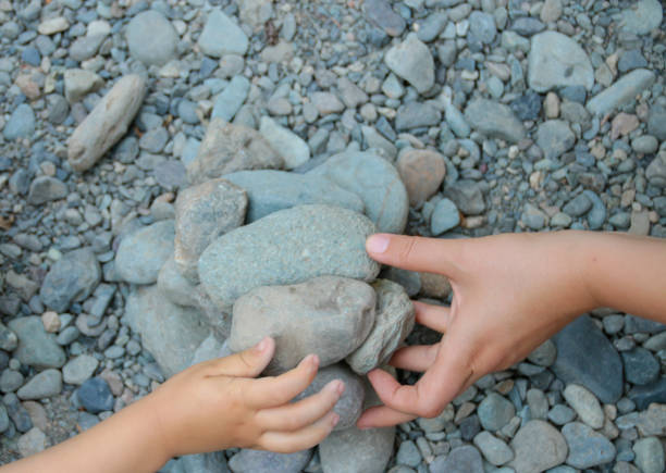 istock Mother and Child Building with Rocks Together 1054048036