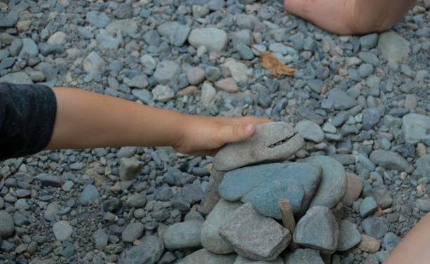 istock Mother and Child Building with Rocks Together 1054048070