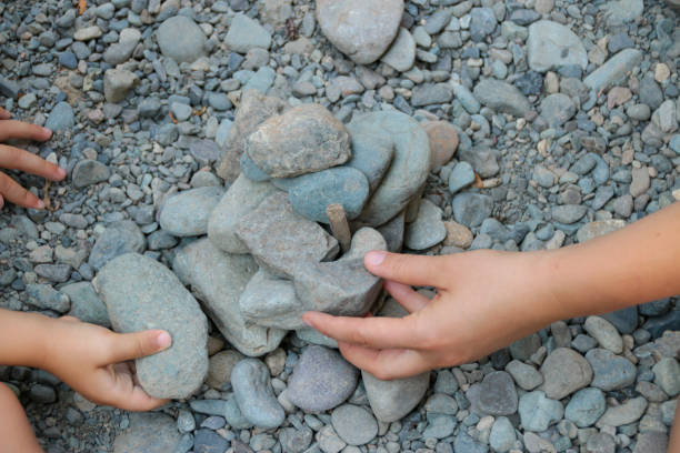 istock Mother and Child Building with Rocks Together 1054048186