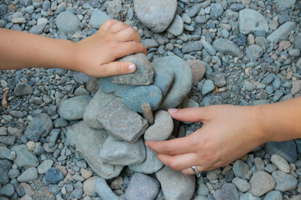 istock Mother and Child Building with Rocks Together 1054048266