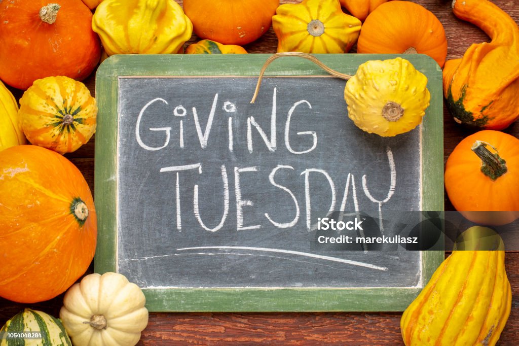 Giving Tuesday blackboard sign Giving Tuesday  - white chalk handwriting on a slate blackboard surrounded by winter squash and gourds Giving Tuesday Stock Photo