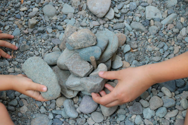 istock Mother and Child Building with Rocks Together 1054048298