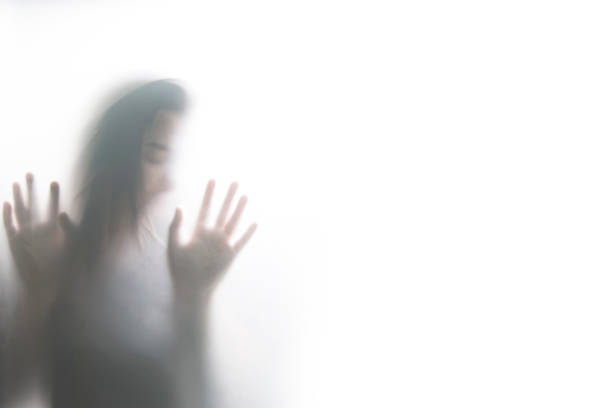 istock Person shadows on Frosted glass 1054061566