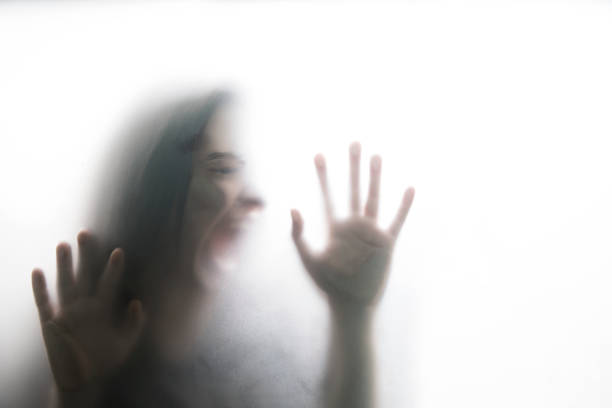 istock Person shadows on Frosted glass 1054061582