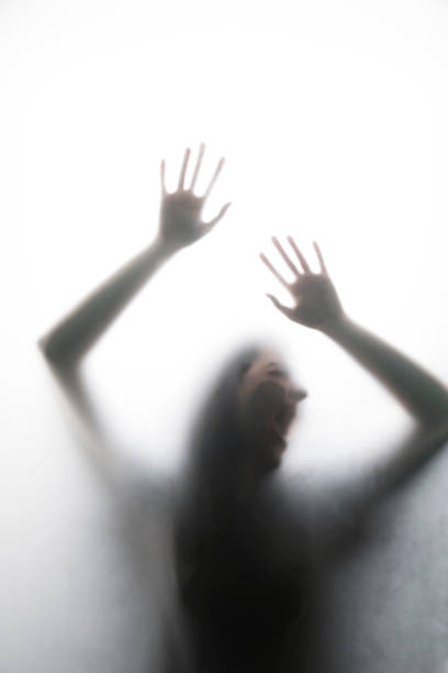 istock Person shadows on Frosted glass 1054061590