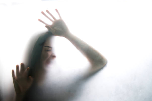 istock Person shadows on Frosted glass 1054062366