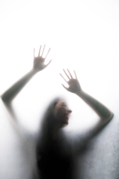 istock Person shadows on Frosted glass 1054062502