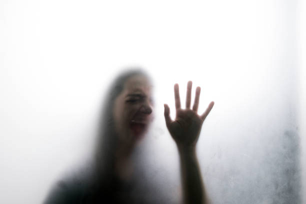istock Person shadows on Frosted glass 1054062718