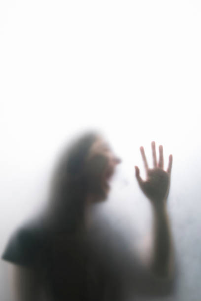 istock Person shadows on Frosted glass 1054062724