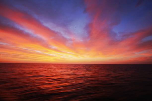 istock Scenic View Of Sea Against Dramatic Sky During Sunset 1054064376