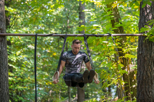 istock Man on gymnastic rings in a forest 1054070206