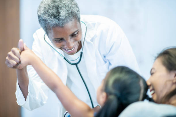 istock Beautiful elderly doctor laughs with her patient 1054070942