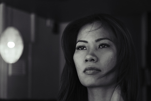 Portrait of an Asian woman looking away - monochrome