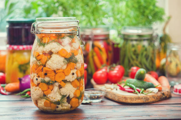 istock Preserving Cauliflower, Carrots and Garlic in Jars 1054081962
